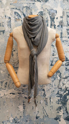 Retro 70’s style scarf with earthy tones and vintage pattern draped on sweater