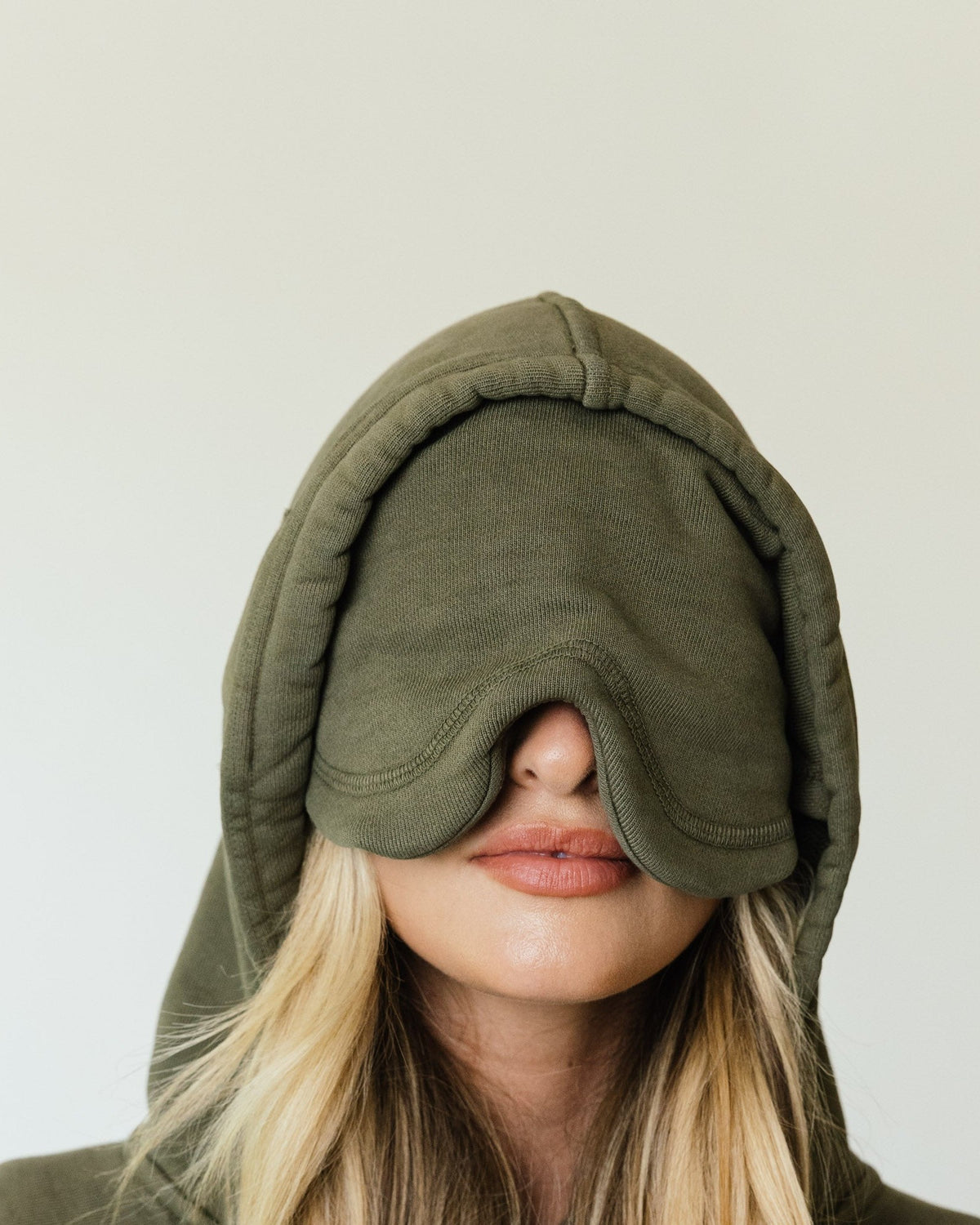 The built-in eye mask folded down from the hood of an olive Apollo X