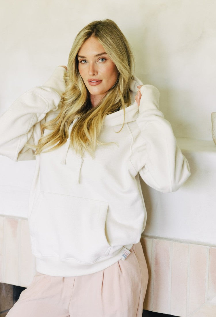 Apollo X in cream, worn at home by the fireplace