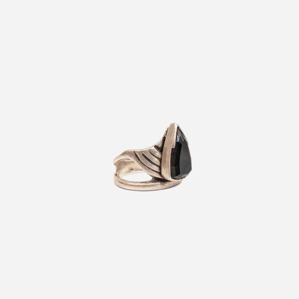 side view of a silver ring with a black stone