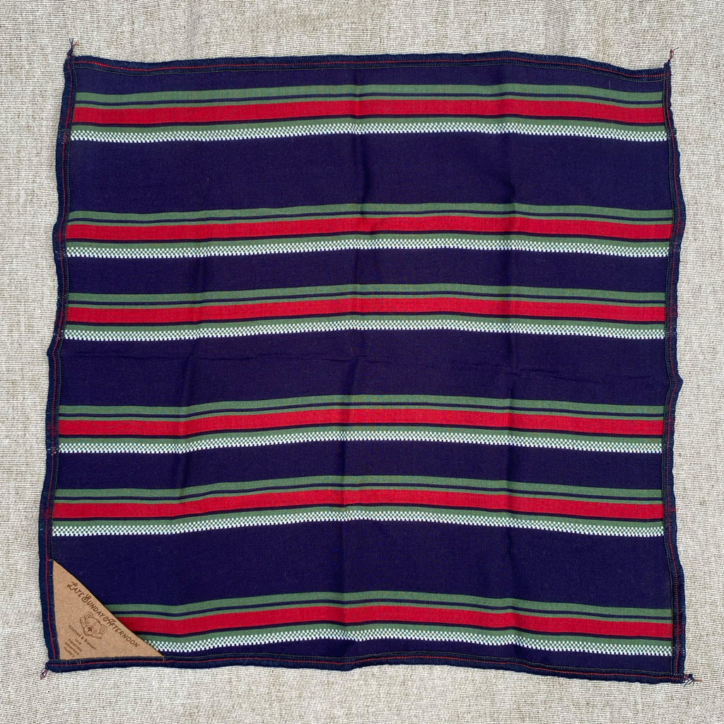 open pocket square with a red, navy, green, and white stripe motif